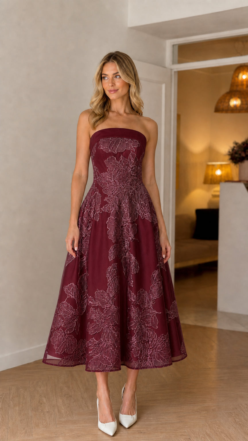 Model wearing burgundy strapless floral embroidered midi dress