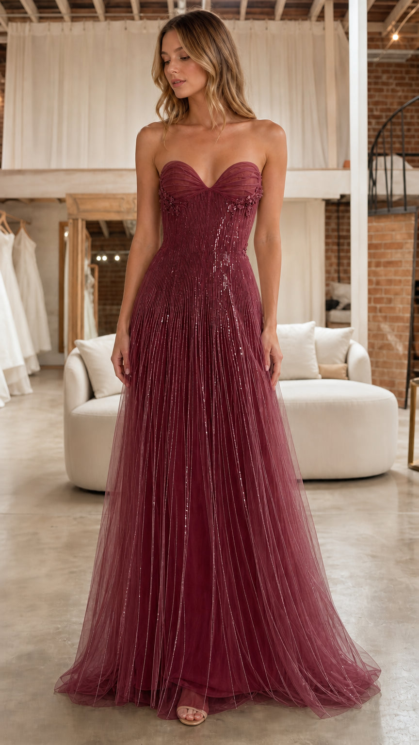 Front full view of model in the burgundy strapless beaded tulle evening gown