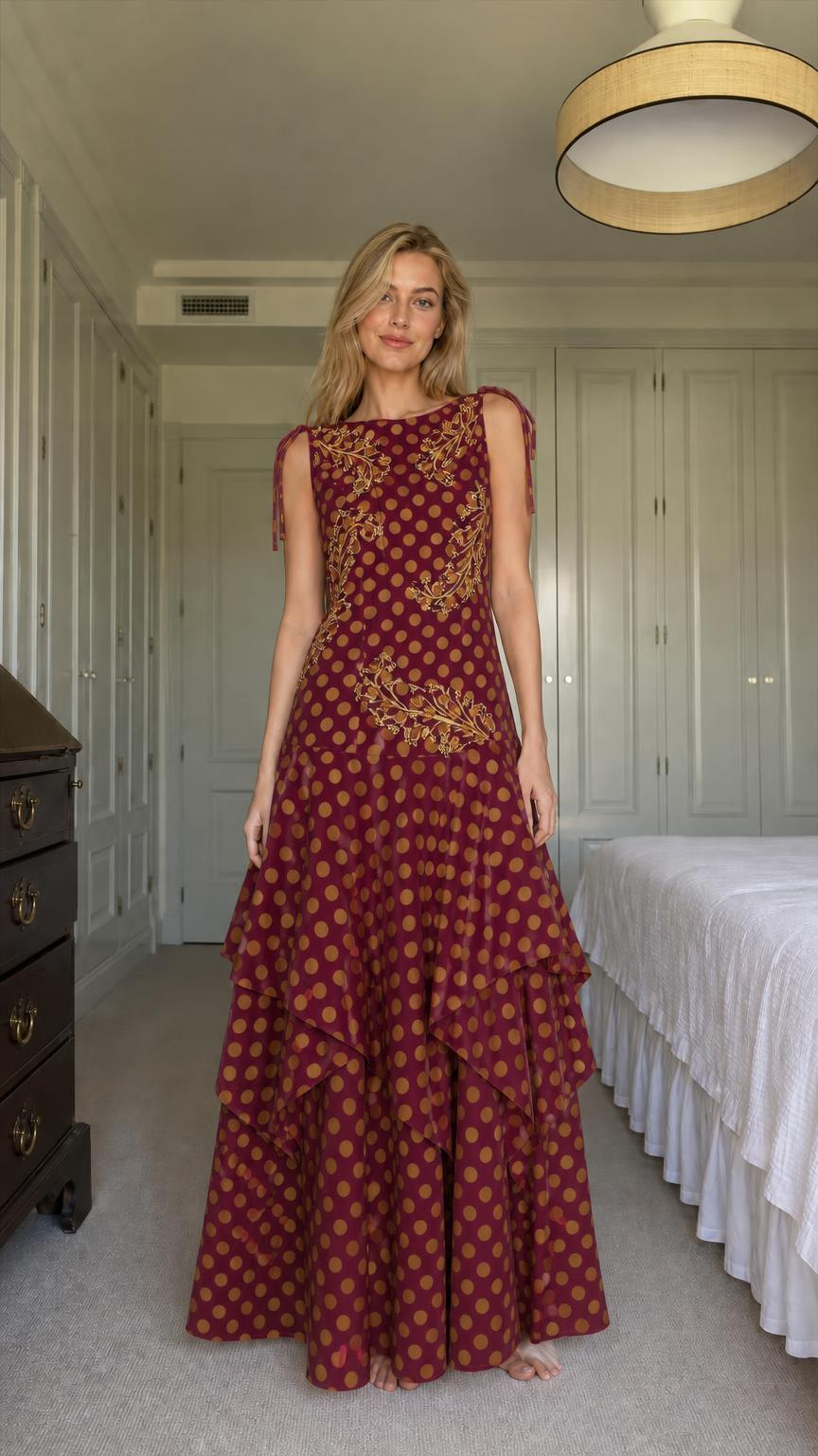 Model wearing burgundy polka dot tiered maxi dress