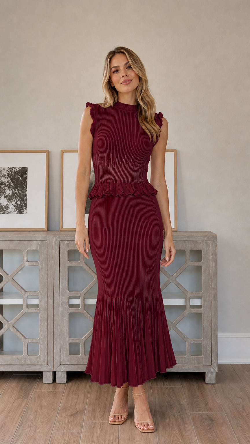 Front full view of woman wearing burgundy pleated midi dress