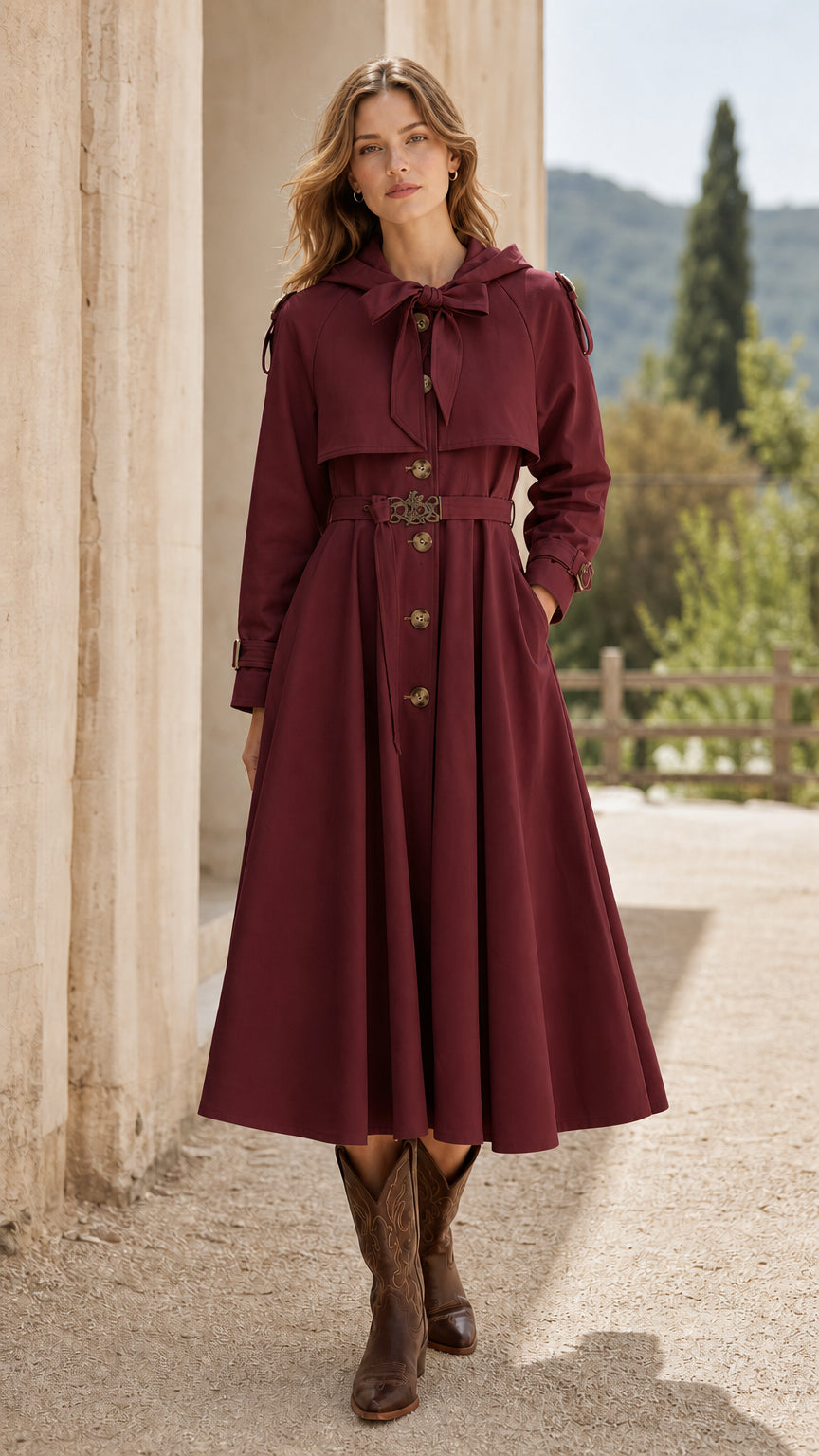 Front view of woman wearing burgundy hooded swing trench coat