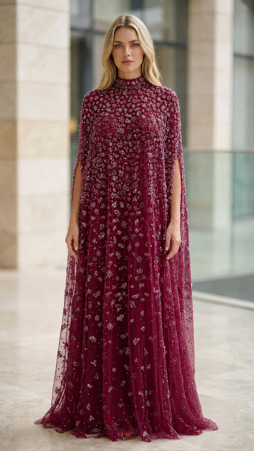 Model wearing burgundy wine red beaded cape evening gown