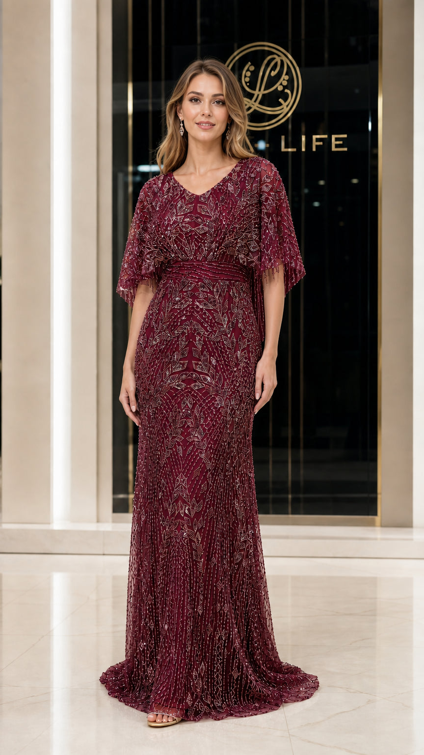 Front view of woman wearing burgundy beaded evening gown