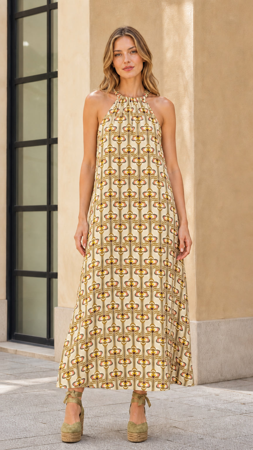 Model wearing beige geo print halter maxi dress