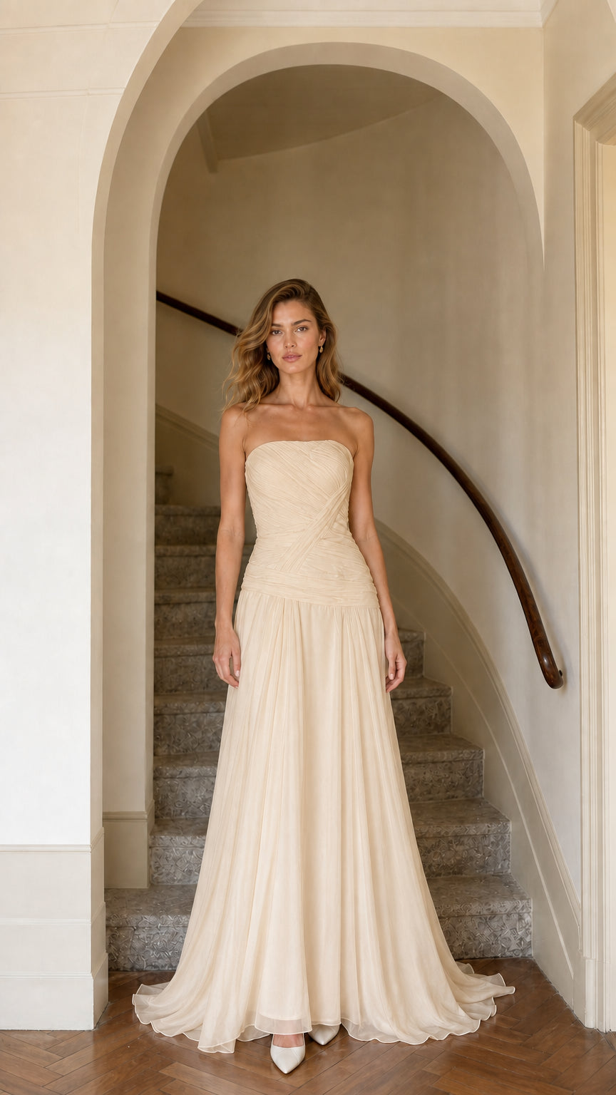 Model wearing champagne beige strapless ruched formal maxi dress