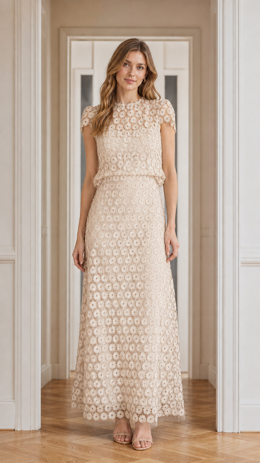 Model wearing champagne floral lace maxi dress, front view