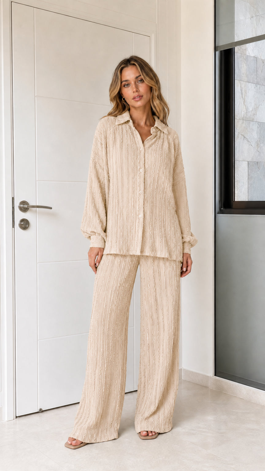 Woman wearing beige textured button-down shirt and wide-leg trousers set