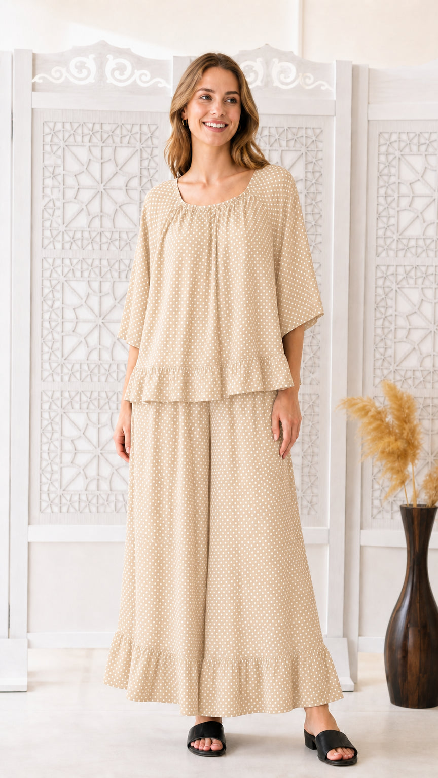 Front view of woman wearing beige polka dot two-piece matching set
