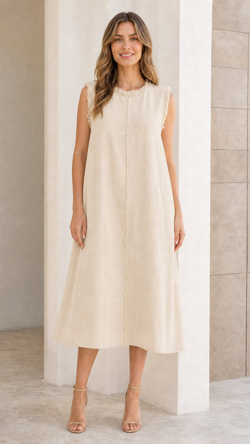 Front view of woman wearing beige sleeveless midi dress
