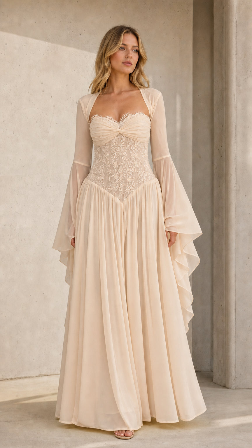 Front view of model wearing cream champagne flared sleeve lace maxi dress