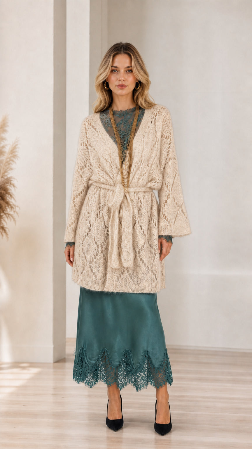 Model wearing beige open front knit cardigan with belt