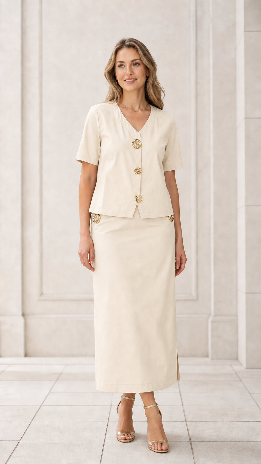 Front full view of woman wearing cream off-white short sleeve blouse and maxi skirt set