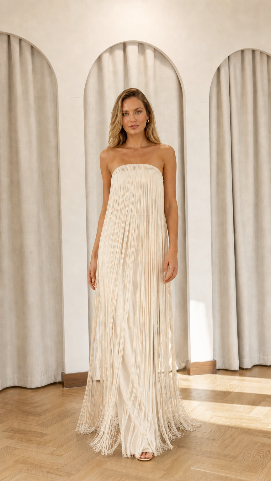Full view of model wearing champagne strapless fringe maxi dress