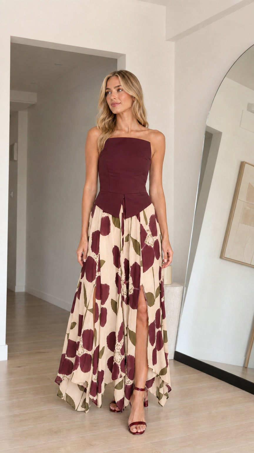 Model wearing burgundy variant of strapless floral maxi dress
