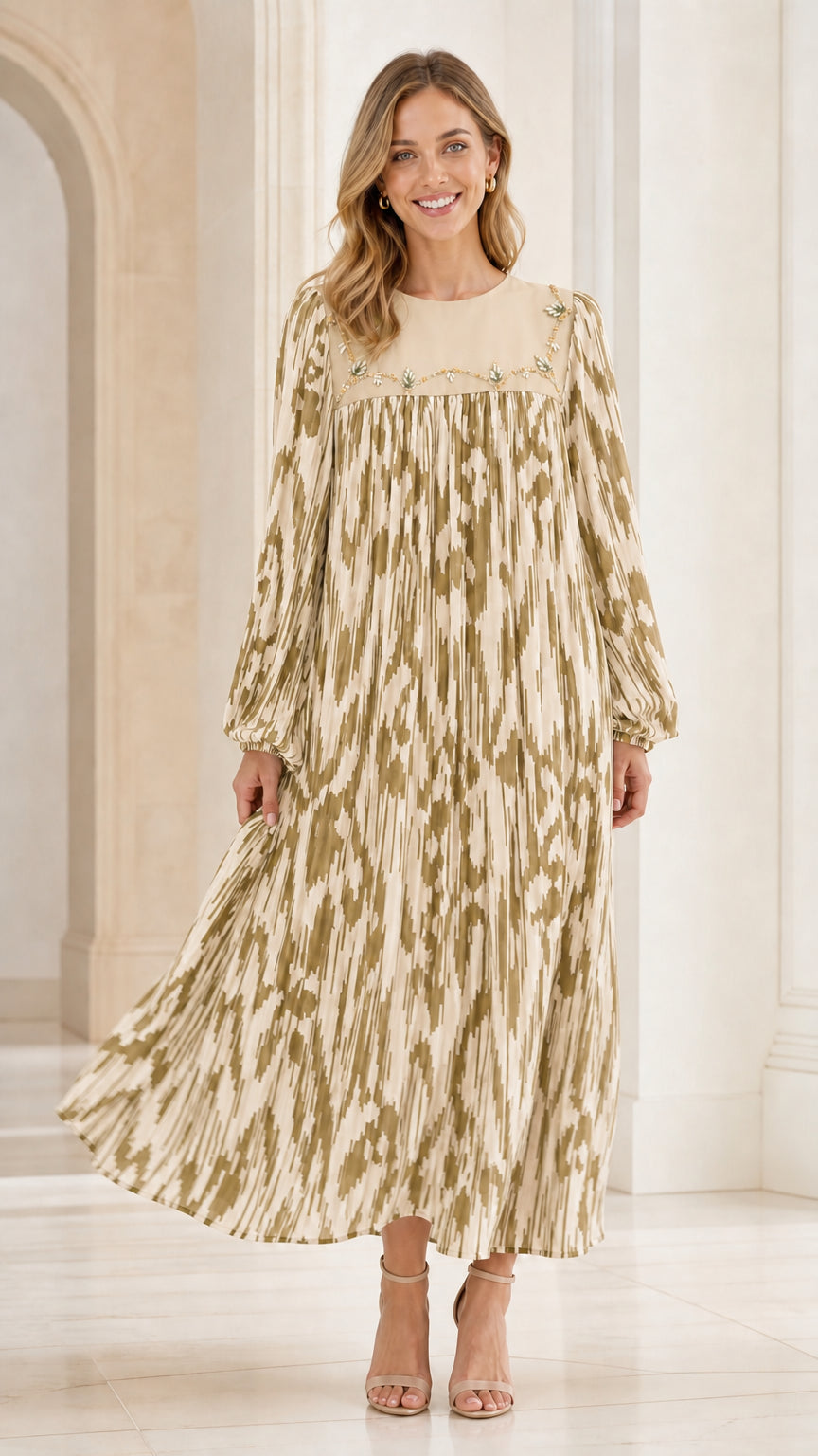 Woman wearing beige and gold tone ikat pleated maxi dress