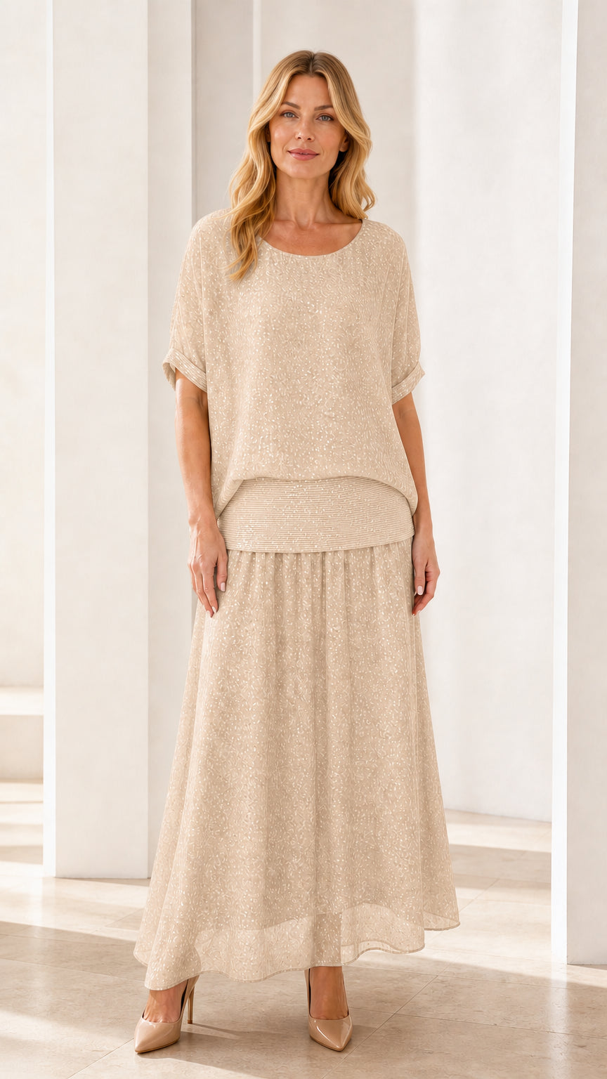Model wearing champagne shimmer two-piece maxi skirt set