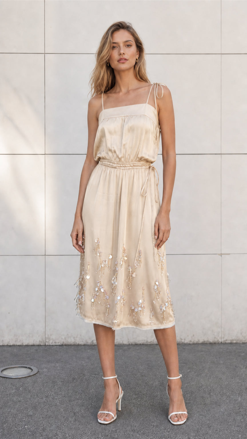 Front view of model wearing champagne satin embellished midi slip dress