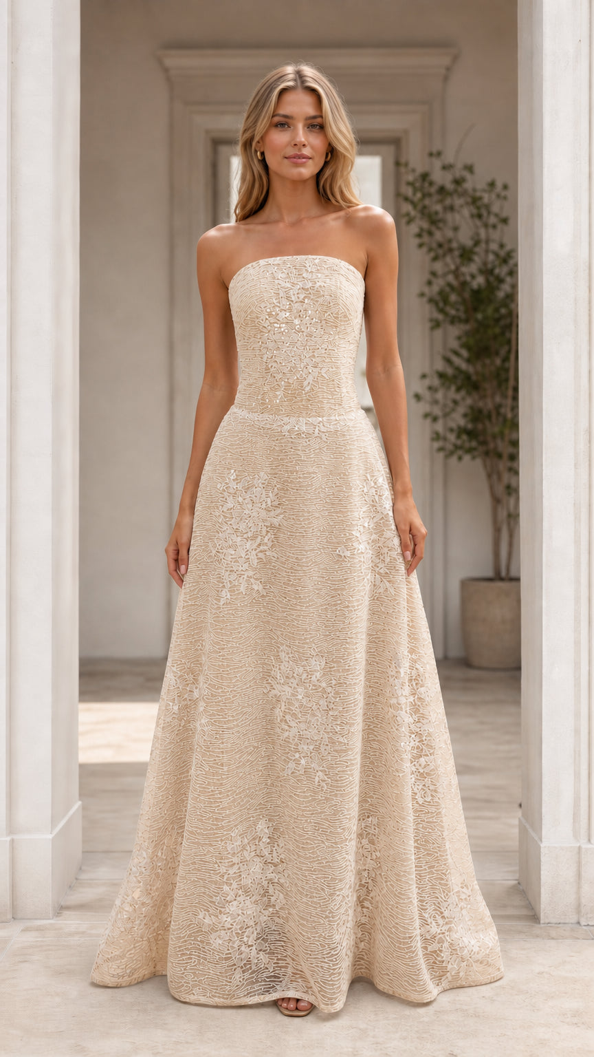 Front view of model wearing champagne strapless formal evening dress