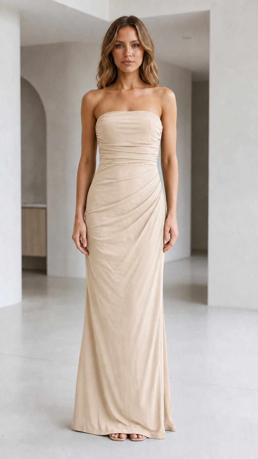 Front view of woman wearing strapless ruched maxi dress in champagne beige