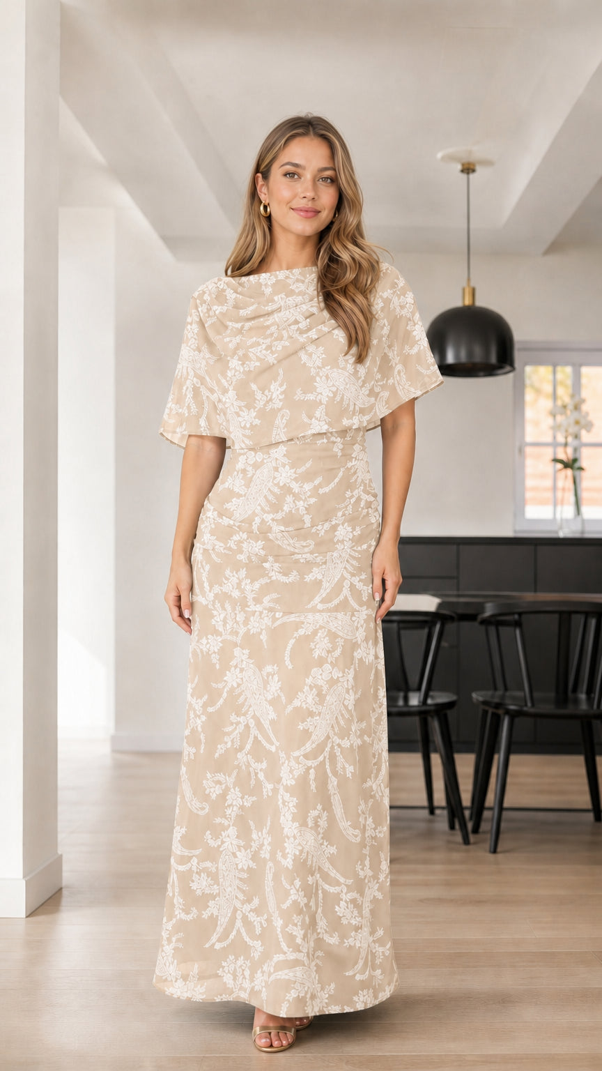 Front view of woman wearing Champagne beige floral textured capelet maxi dress
