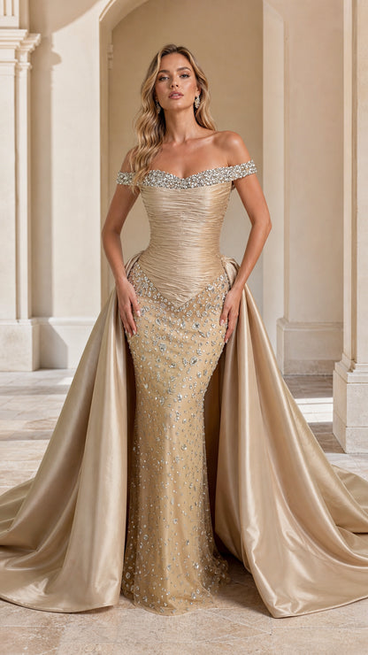 Front view of model wearing Champagne off-the-shoulder beaded evening gown with overskirt