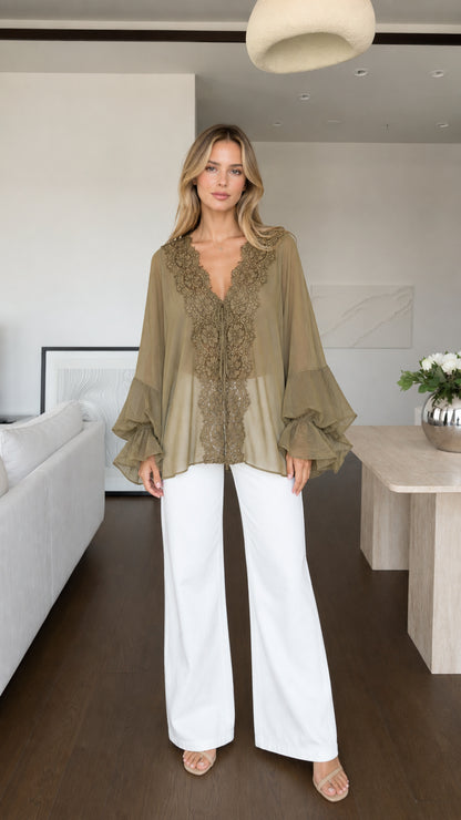 Model wearing olive boho lace trim blouse with white trousers front view