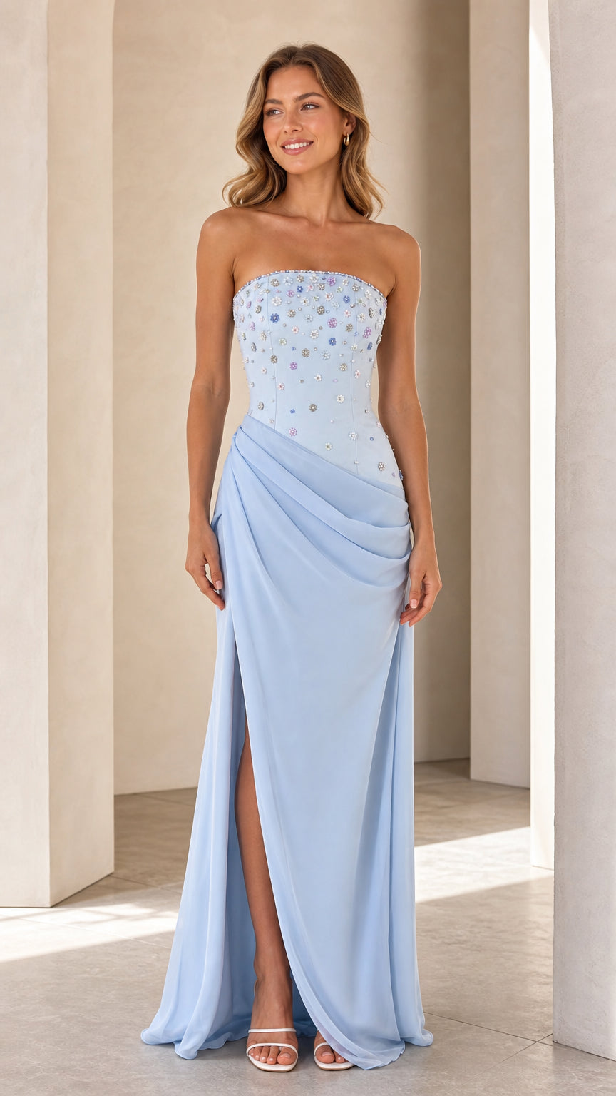 Front view of model wearing Light Blue strapless beaded bodice evening gown with draped waist and slit