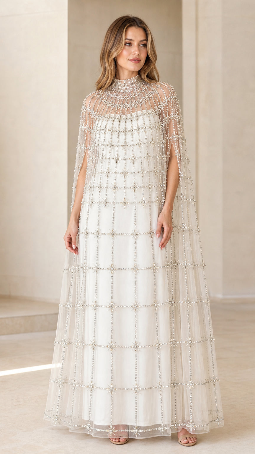 Front view of model wearing Ivory White high neck beaded cape evening gown