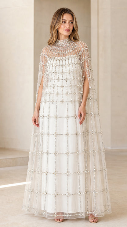 Front view of model wearing Ivory White high neck beaded cape evening gown