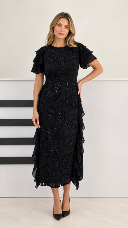 Front view of model wearing black beaded midi dress