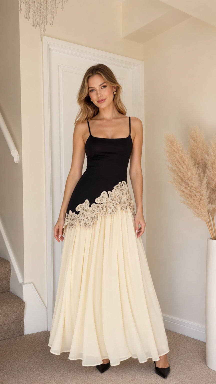 Front view of woman wearing black and champagne contrast lace long slip dress