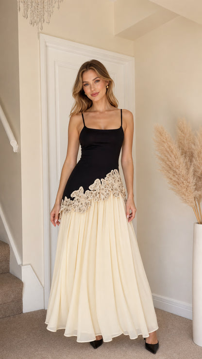 Front view of woman wearing black and champagne contrast lace long slip dress
