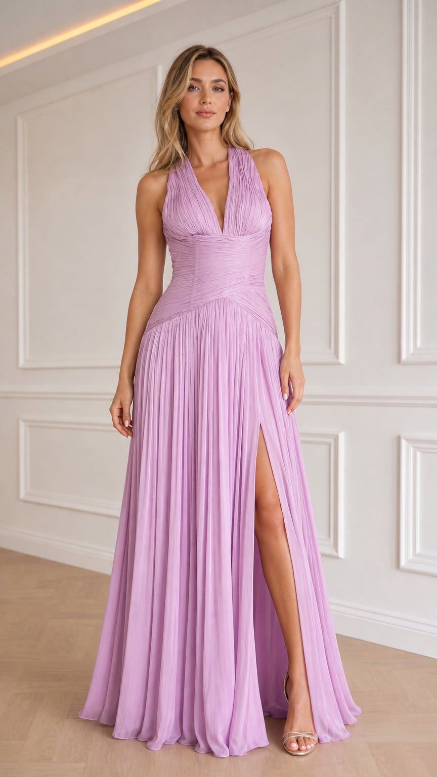 Model wearing lavender halter pleated long evening dress from the front with leg slit