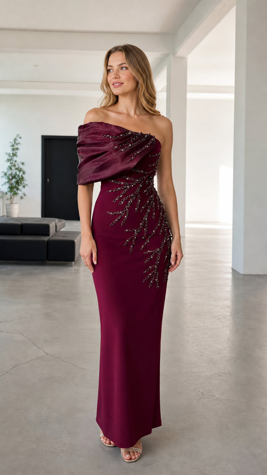 Front view of woman wearing burgundy asymmetric draped beaded evening maxi gown