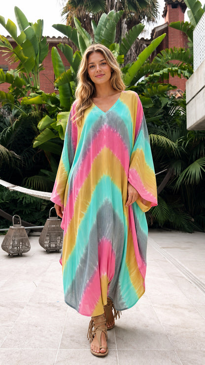 Front view of model wearing vibrant multi-color tie-dye kaftan dress
