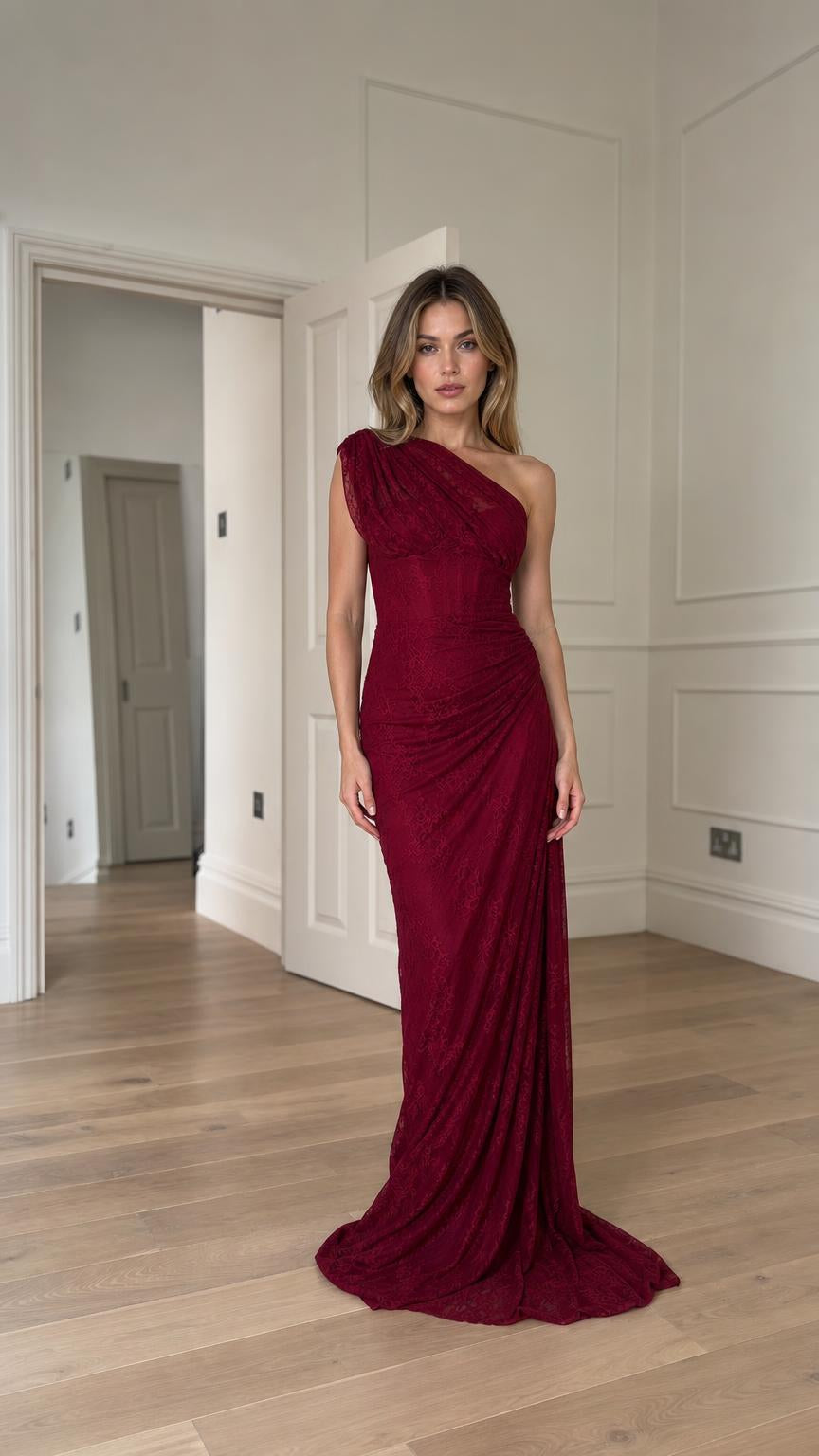 Front view of model wearing burgundy one-shoulder ruched lace evening gown