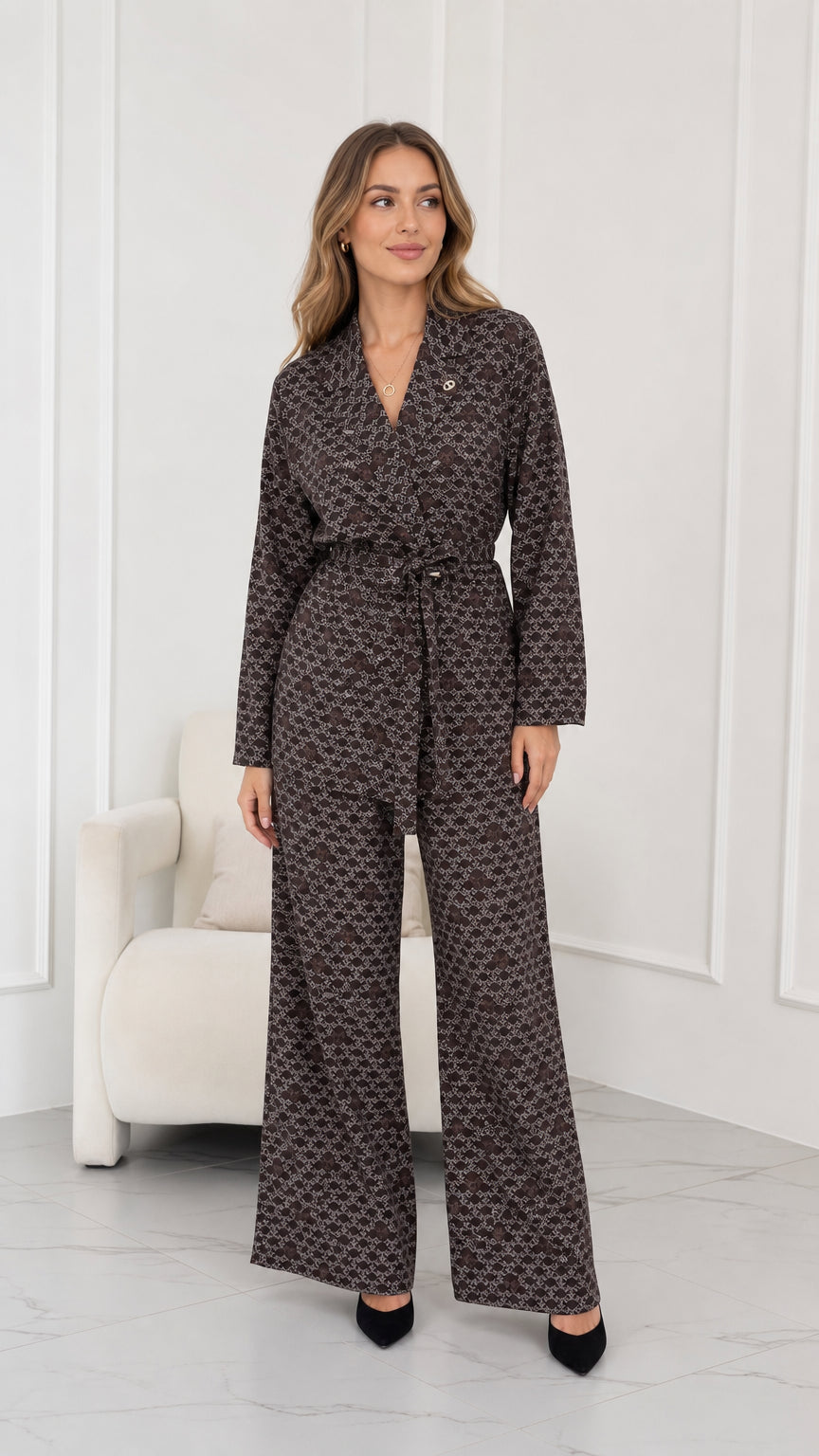 Full front view of model wearing brown geometric print belted blazer and wide leg pants set