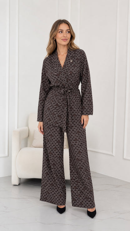 Full front view of model wearing brown geometric print belted blazer and wide leg pants set