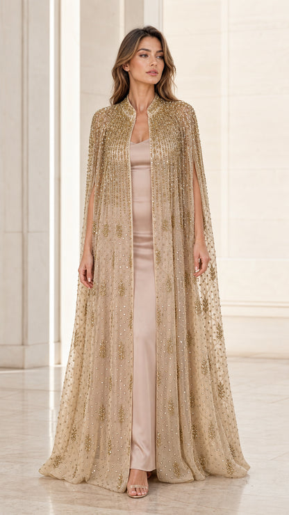Front view of model wearing floor-length champagne gold beaded evening cape gown