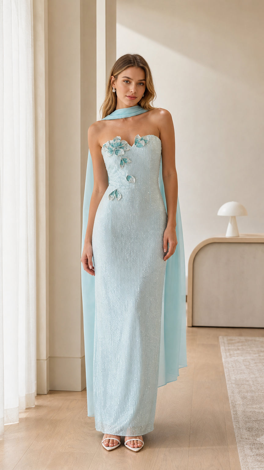 Front full view of light blue strapless sequin column evening gown with 3D floral applique and chiffon cape