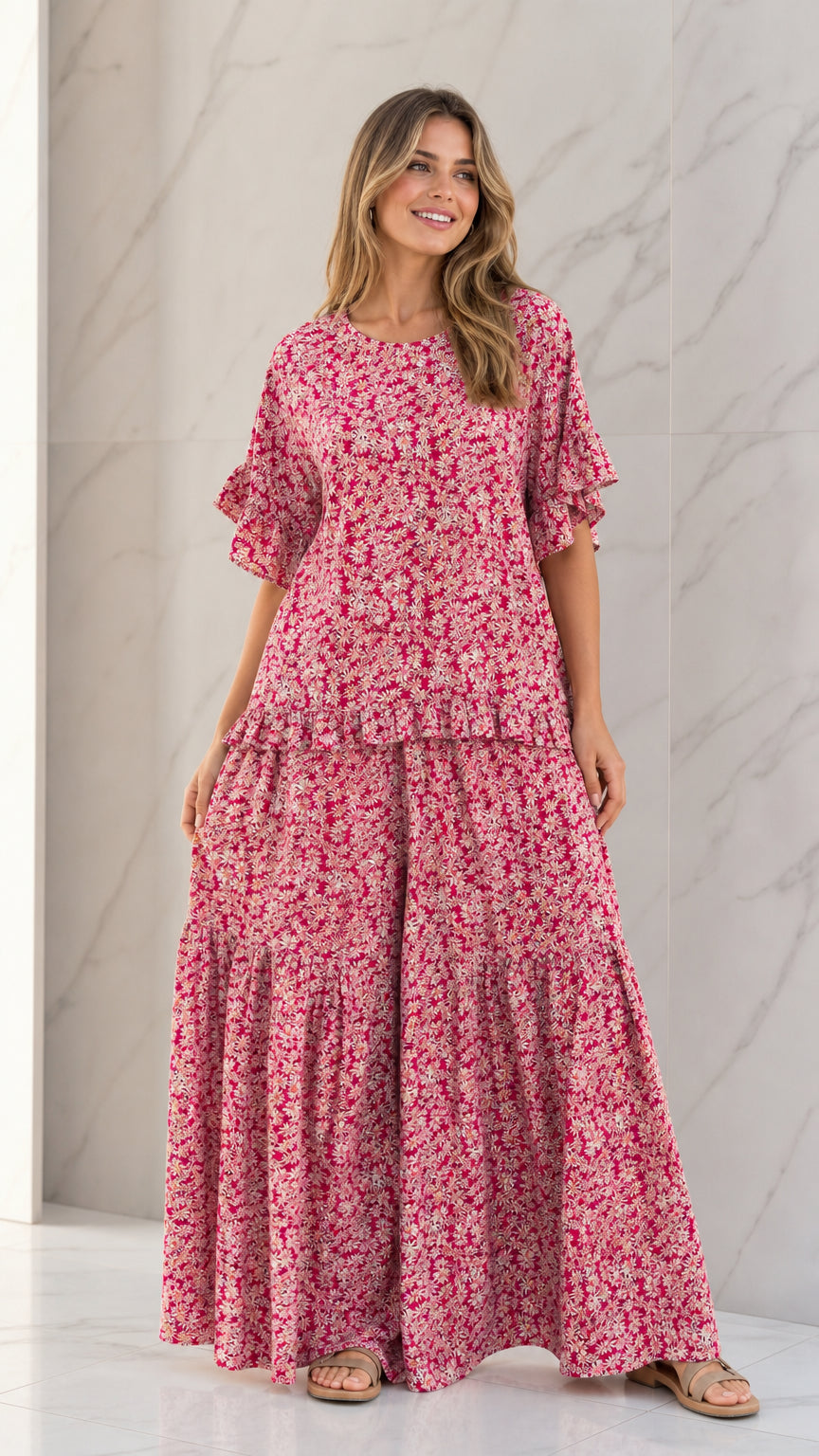 Front full view of woman wearing Rose Pink floral ruffle sleeve top and tiered wide-leg pants set