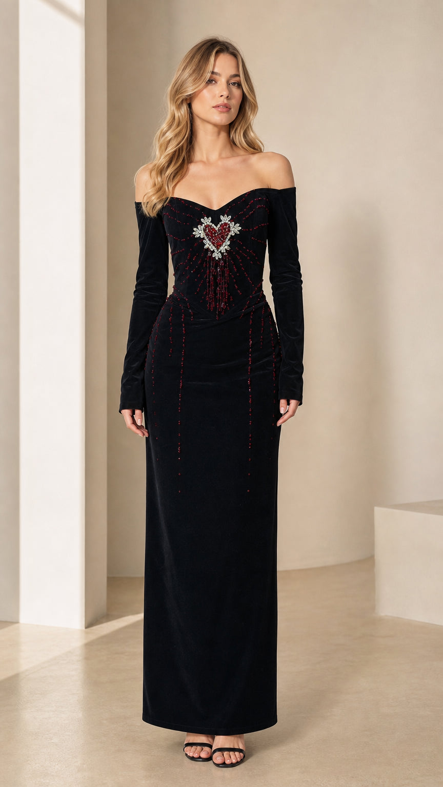 Model wearing black off-the-shoulder long sleeve velvet maxi dress with beaded heart bodice