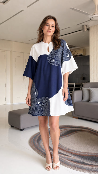 Model wearing blue and white color-block shift dress, front view