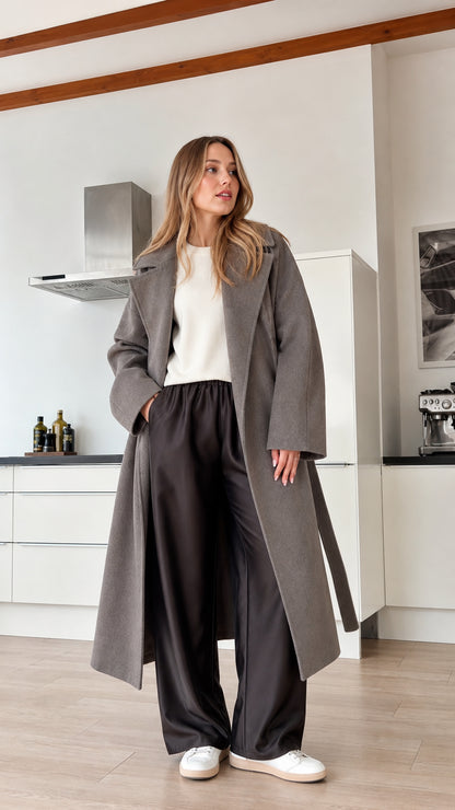 Model wearing grey longline belted wrap coat front view