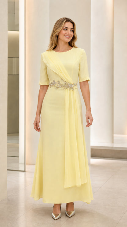 Full front view of model wearing pastel yellow short sleeve maxi formal dress with beaded waist