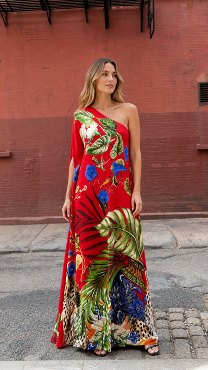 Front view of model wearing red tropical print one-shoulder maxi dress