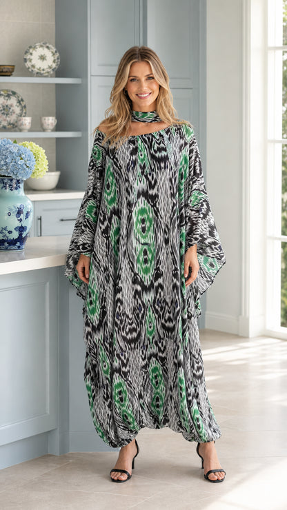 Front full view of woman wearing emerald green Ikat print kaftan maxi dress with matching neck scarf