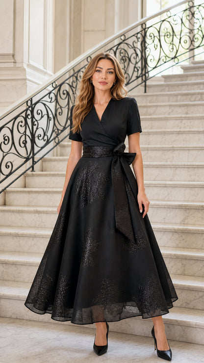Front view of black V-neck A-line midi dress on model