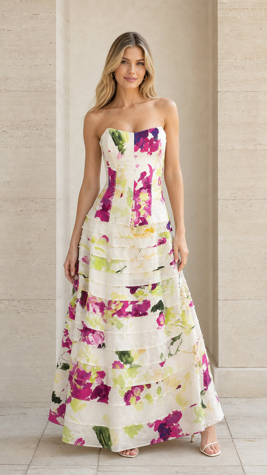 Front view of model wearing ivory strapless floral tiered maxi evening gown