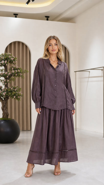 Front view of a mauve women's blouse and flowing maxi skirt two-piece set